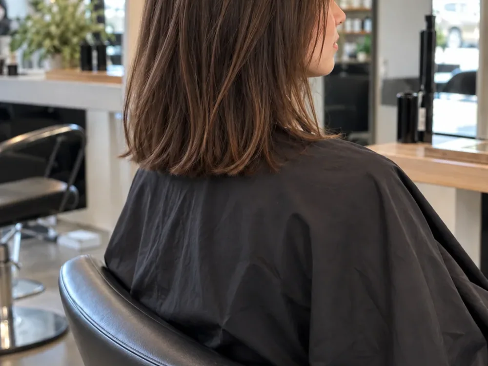 After: the same hair cut to a collarbone-length lob with soft layers